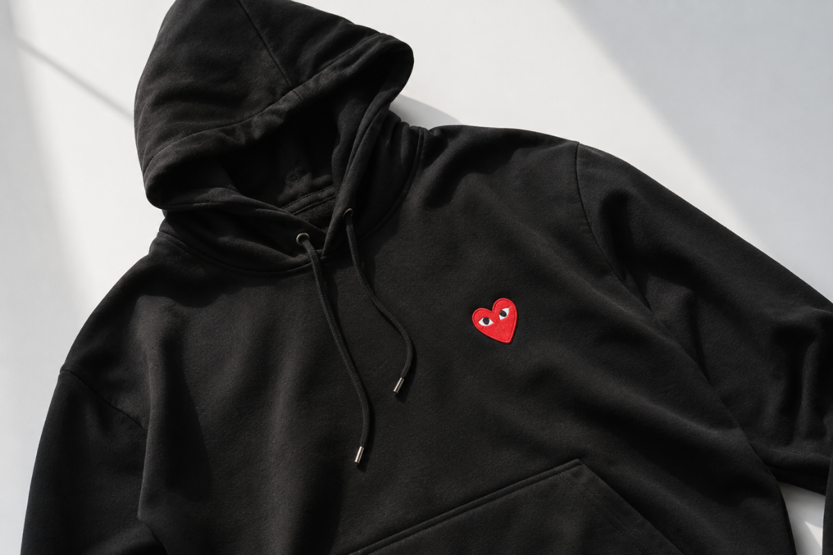CDG Play brand black hoodie with red heart logo on chest